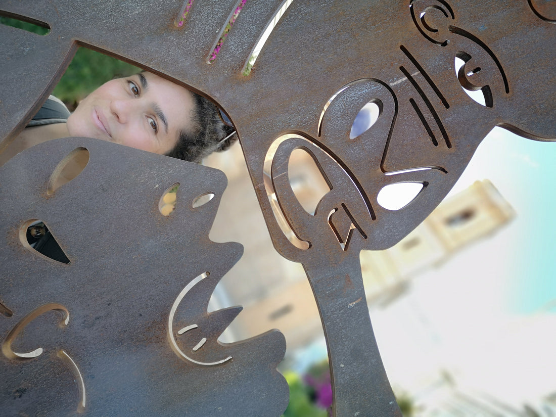 Image of Dani, founder of Contemporanea, looking through a metal sculputure, tribute to Pablo PIcasso's Guernica. Spain